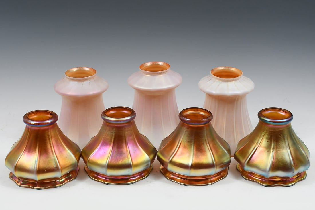 7 PC STEUBEN ATTRIBUTED & QUEZAL ART GLASS SHADES: 7 PC. STEUBEN ATTRIBUTED & QUEZAL ART GLASS SHADES: Four gold Aurene glass shades attributed to Steuben, unsigned, measuring approx. 4'' h x 5'' w. Accompanied by three Quezal art glass lamp shades of
