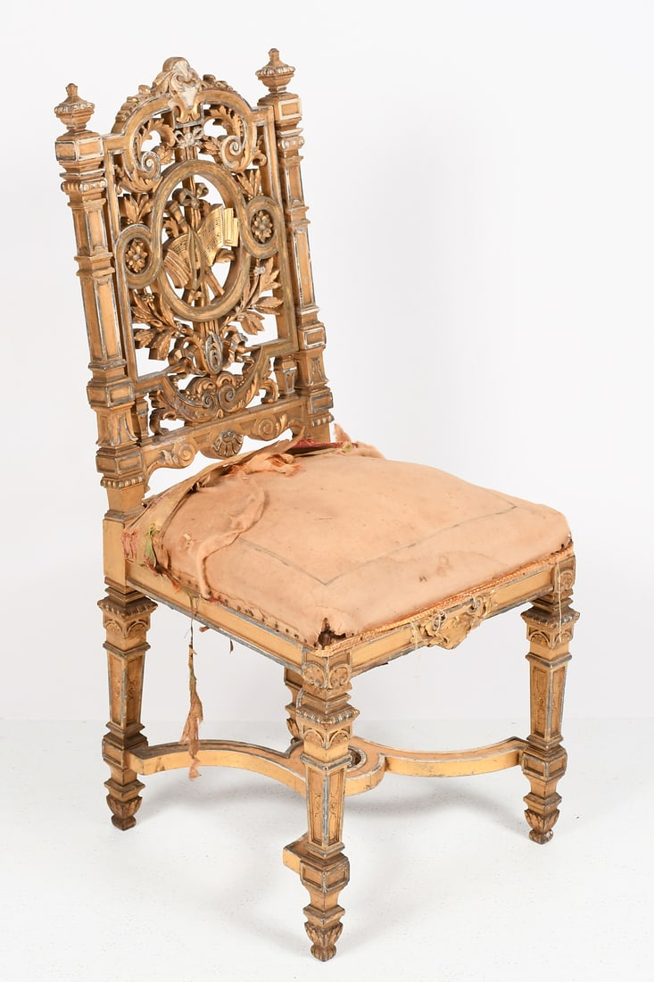CARVED & GILT AESTHETIC MOVEMENT SIDE CHAIR: CARVED & GILT AESTHETIC MOVEMENT SIDE CHAIR: A highly carved giltwood & gesso chair with ornate openwork backrest having a scroll & foliate motif surrounding a music sheet & instrument motif central m