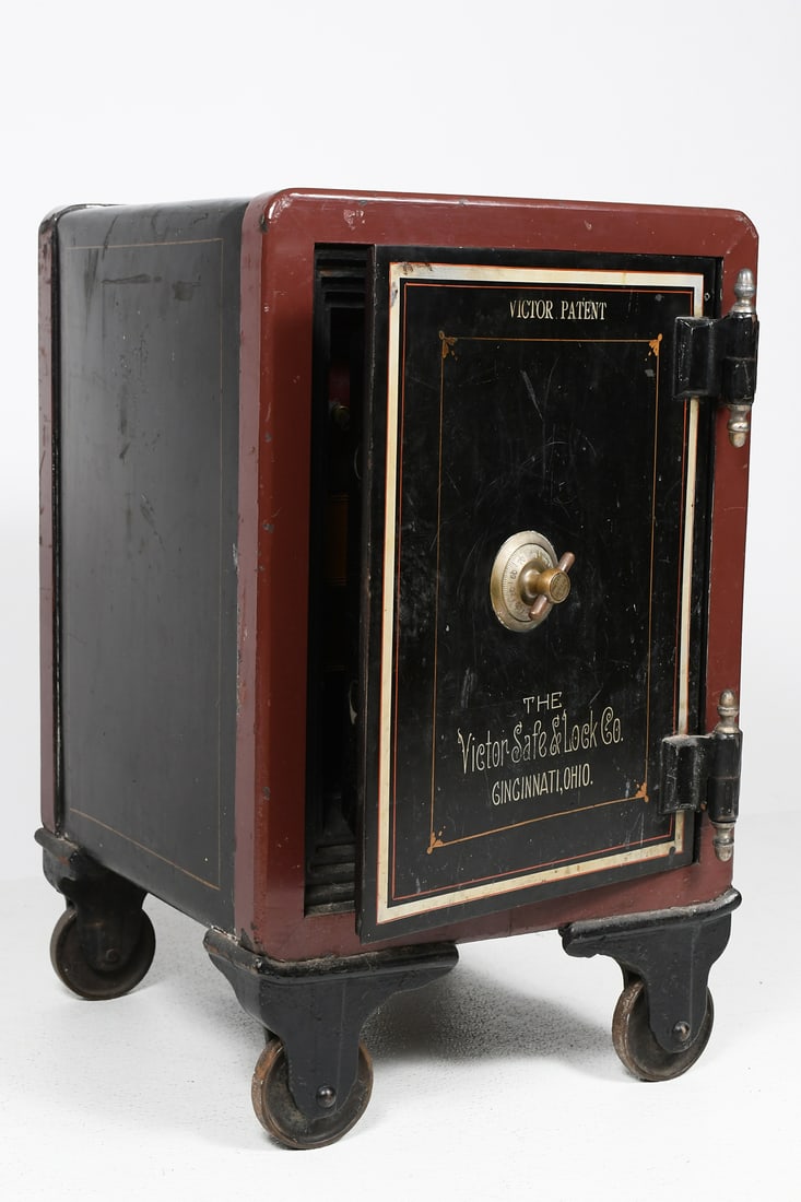 ANTIQUE SAFE BY VICTOR SAFE & LOCK CO.: ANTIQUE SAFE BY VICTOR SAFE & LOCK CO.: Cast iron safe by Victor Safe & Lock Co. Black exterior with decorative stencil reading ''The Victor Safe & Lock Co. Cincinnati, Ohio.'' and ''Victor Patent'' a