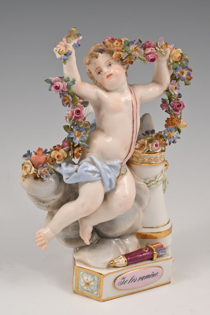 MEISSEN PORCELAIN PUTTI ''JE LES RAMENE'' SCULPTURE: MEISSEN PORCELAIN PUTTI ''JE LES RAMENE'' SCULPTURE: This wonderful Meissen porcelain figure portrays Cupid holding an ornate floral garland as he sits atop a cloud with a column at his side. His quiv