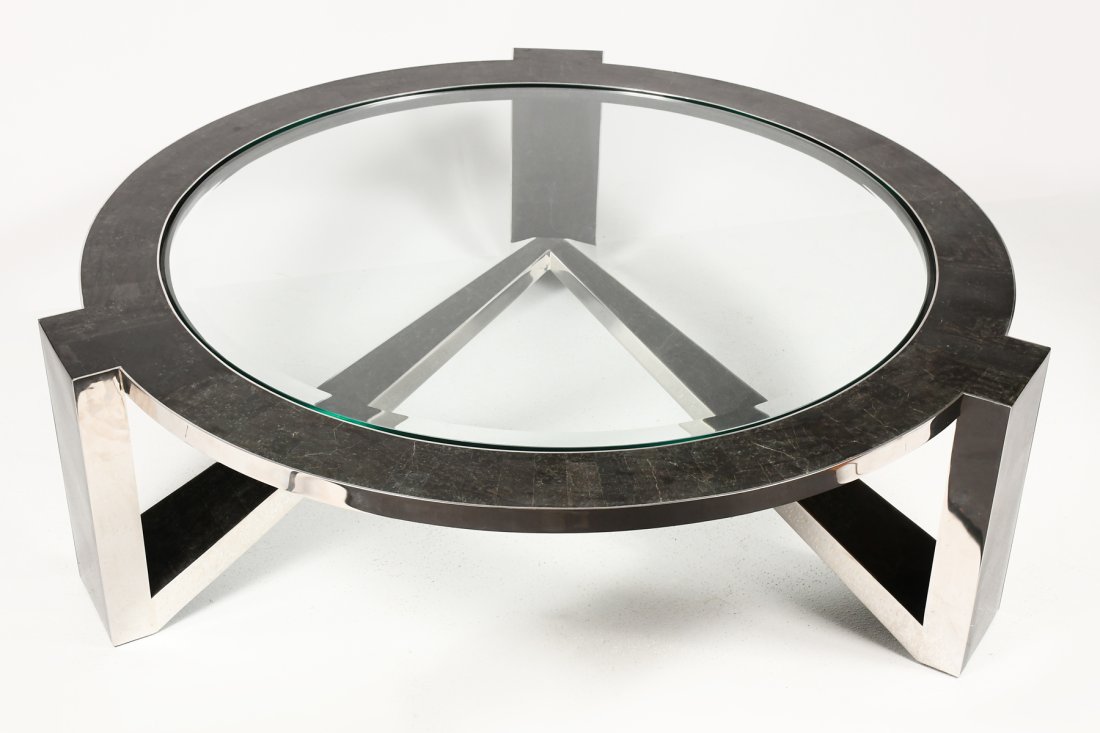 TAVOLA BY OGGETTI GLASS & COMPOSITE COFFEE TABLE: TAVOLA BY OGGETTI GLASS & COMPOSITE COFFEE TABLE: Oggetti Triton round coffee table having an inset glass surface within stainless steel frame. With a black fossil stone & polished stainless finish. A