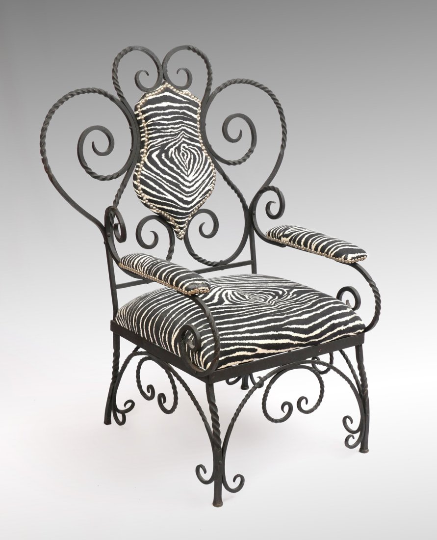 WROUGHT IRON UPHOLSTERED CHAIR: WROUGHT IRON UPHOLSTERED CHAIR: Having an overall scrolling & twisted wrought iron frame, upholstered in a Zebra pattern fabric. Approx. 45.5'' h x 35'' l x 28.25'' w.