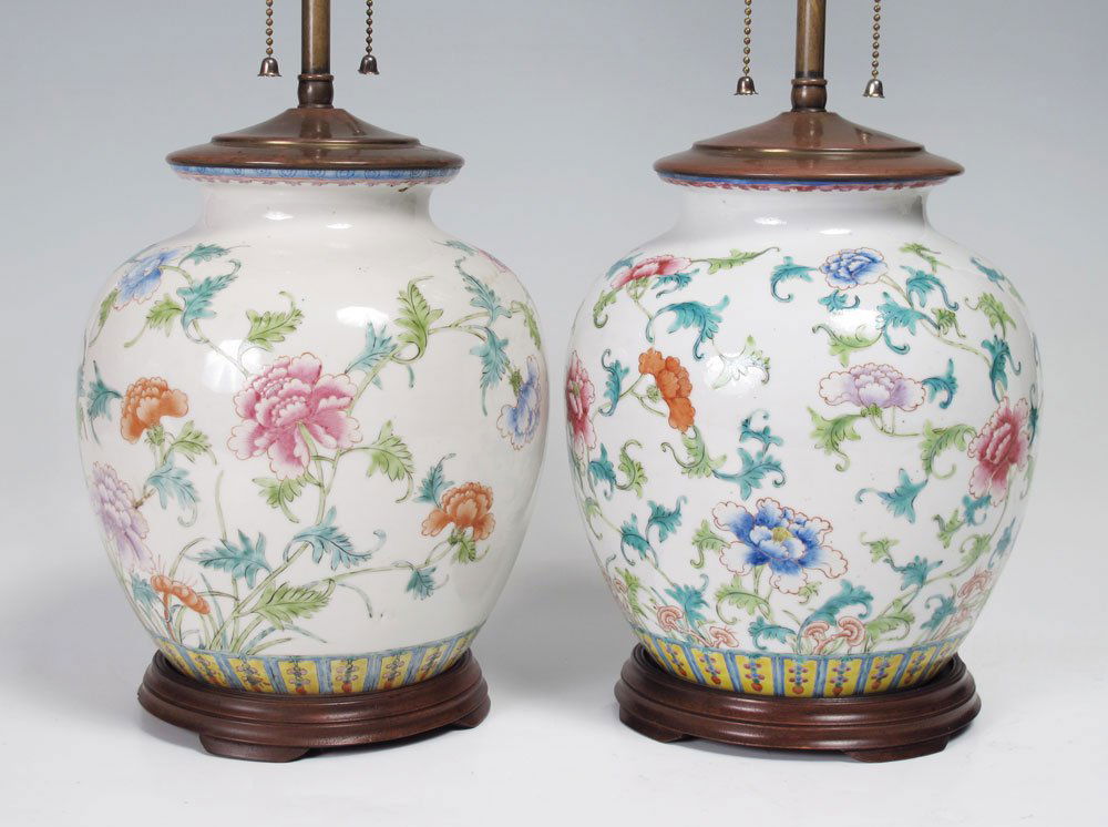PAIR CHINESE POLYCHROME CERAMIC LAMPS: PAIR CHINESE POLYCHROME CERAMIC LAMPS: Floral motif Chinese export earthenware bodies on wood bases. Overall measure 20 1/2" h. x 8" dia. Sold with newer cloth shades 9" h. x 14 1/4" dia.