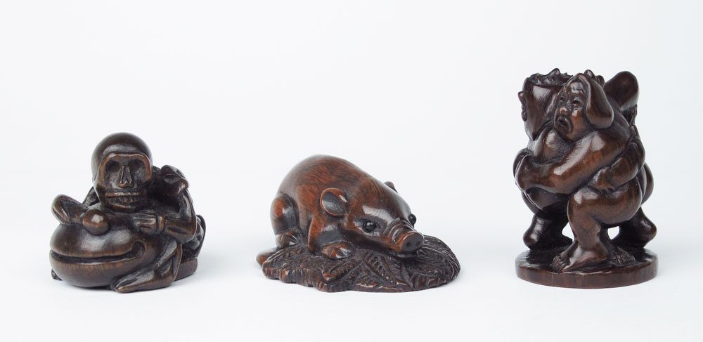 3 FINELY CARVED WOOD NETSUKES: 3 FINELY CARVED WOOD NETSUKES: To include 1) Skeleton on a toad, signed, 1 1/4" h. 2) Boar on a leaf, signed, 7/8" h. 3) 2 figures wrestling, signed, note split in base, 1 3/4".