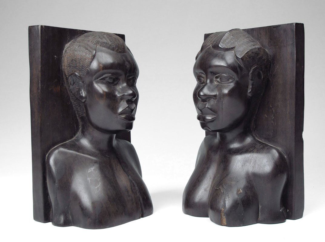 AFRICAN CARVED EBONY BOOKENDS: AFRICAN CARVED EBONY BOOKENDS: Featuring a bust of a woman and man. Each measures 8 7/8'' h. x 5 3/4'' x 3 1/2''.