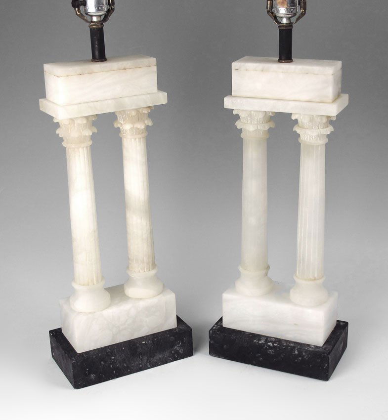 PAIR ALABASTER GREEK REVIVAL LAMPS: PAIR ALABASTER GREEK REVIVAL LAMPS: Each alabaster lamp with 2 fluted columns with acanthus leaf necking, over grey marble base. Alabaster finials. Overall measures 29 1/4" h. x 8 1/4" x 4 1/2". Sold