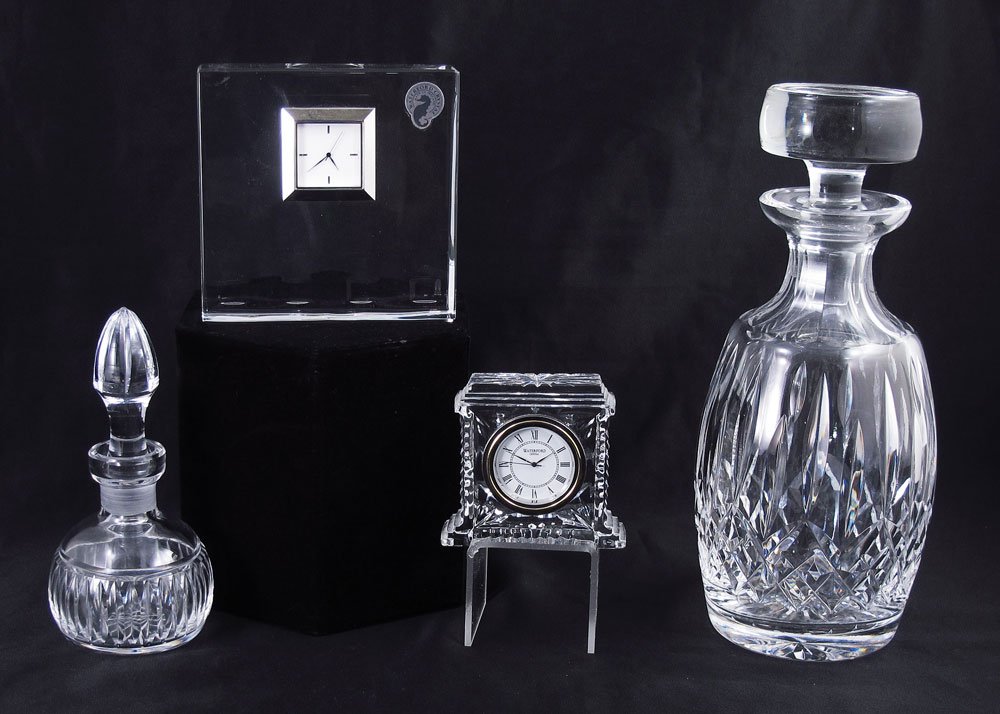 4 PIECE COLLECTION OF WATERFORD CRYSTAL: 4 PIECE COLLECTION OF WATERFORD CRYSTAL: To include 1) Decanter, note chips to stopper, 9 3/4" h. x 4" dia. 2) Perfume, 6" h. x 2 3/4" dia. 3) Small clock, 2 7/8" h. 4) Larger clock, 4 1/2" h.