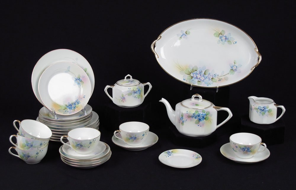 HAND PAINTED NIPPON LUNCHEON SET: HAND PAINTED NIPPON LUNCHEON SET: Floral decorated and gilt rim, approx. 29 pieces to include 6 luncheon plates (7 3/4"), 5 bread and butter, 6 cups and saucers, platter (13 1/4" x 8 1/4"), teapot, op