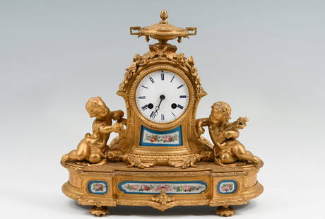 FRENCH V. BILLIET & ROBLIN FIGURAL GILT BRONZE CLO: FRENCH V. BILLIET & ROBLIN FIGURAL GILT BRONZE CLOCK: A French gilt bronze figural mantle clock with porcelain enameled dial flanked by two putti figures, the ornated case set with hand-painted polych