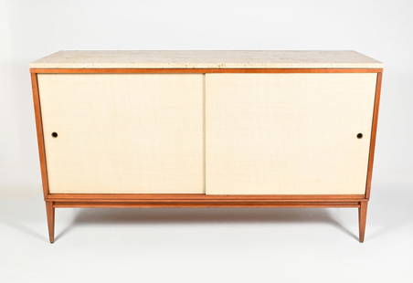 PAUL MCCOBB PLANNER GROUP SIDEBOARD/CREDENZA: PAUL MCCOBB PLANNER GROUP SIDEBOARD/CREDENZA: A mid-century Planner Group sideboard designed by Paul McCobb. With sliding doors opening to a single drawer at the left and three stacked drawers at the