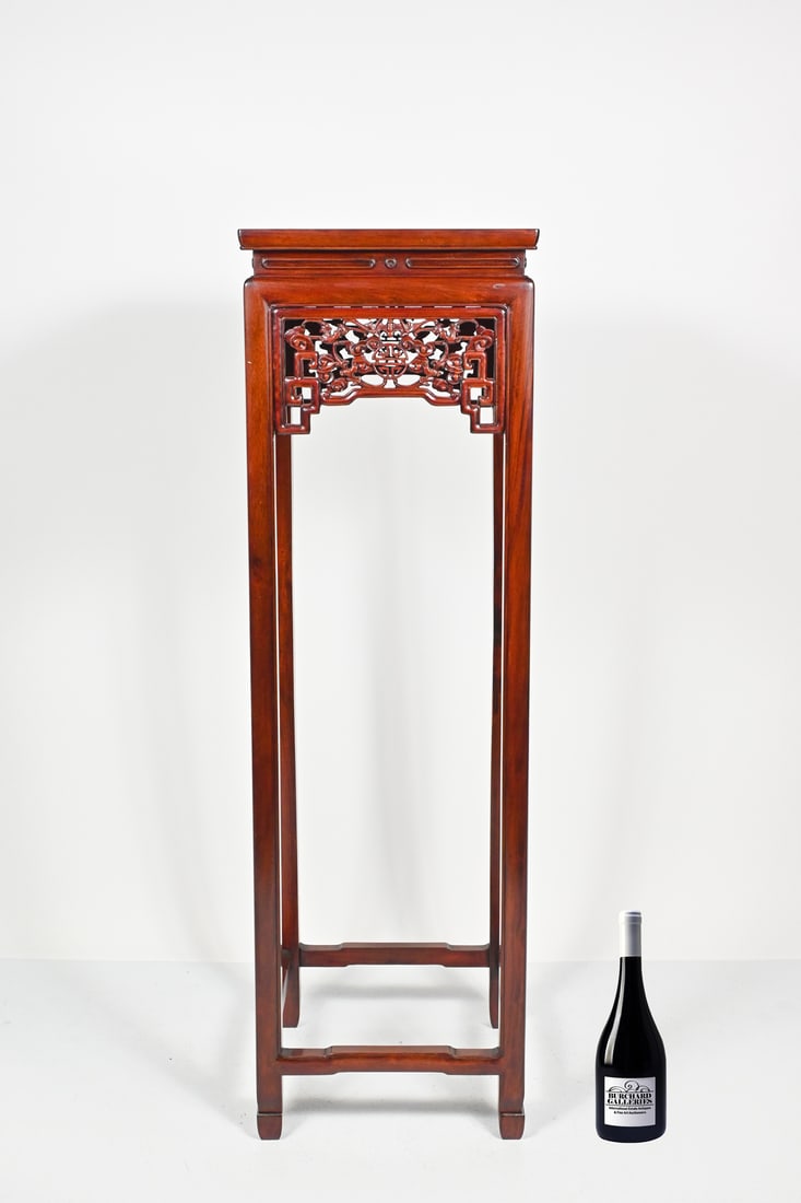 TALL CARVED CHINESE ROSEWOOD PLANT STAND: TALL CARVED CHINESE ROSEWOOD PLANT STAND: A carved Chinese Rosewood plant stand with pierced panels, having stylized Bat & Cloud motif. Approx. 49.75" h x 15" wide.