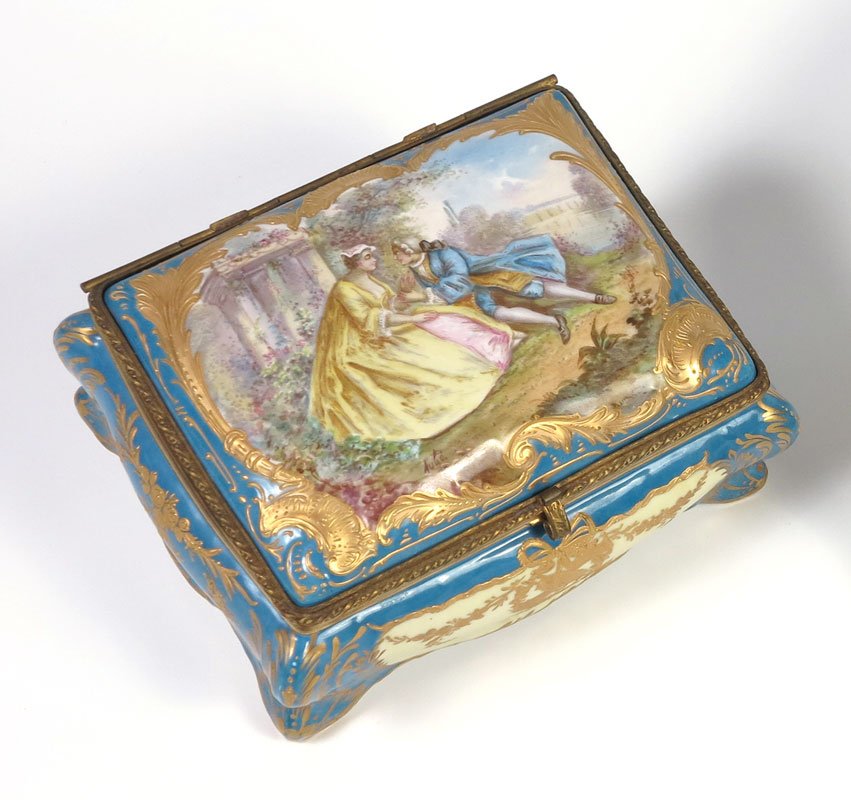 LARGE FINE FRENCH SEVRES STYLE PORCELAIN BOX: FINE FRENCH PORCELAIN BOX IN THE MANNER OF SEVRES: Hand painted courting scene on the hinged top, framed by raised gold scroll work. The interior with hand painted floral sprays. Bombay sides, scrolle