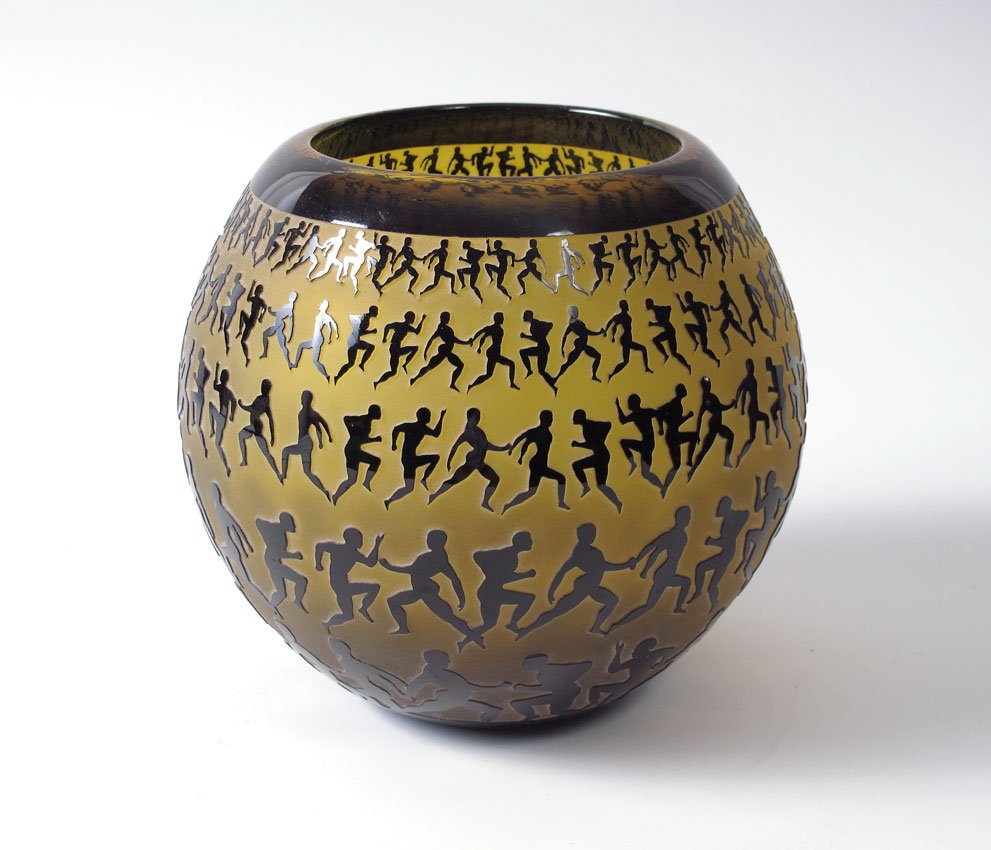 DUNCAN McCLELLAN METAMORPHASUS ART GLASS: McCLELLAN, Duncan, (American 1955-): ''Metamorphosis'' black over amber overlay glass vase with sand carved images of the changing man. Approx. 8 1/2'' dia. Signed. Original retail was $1200.