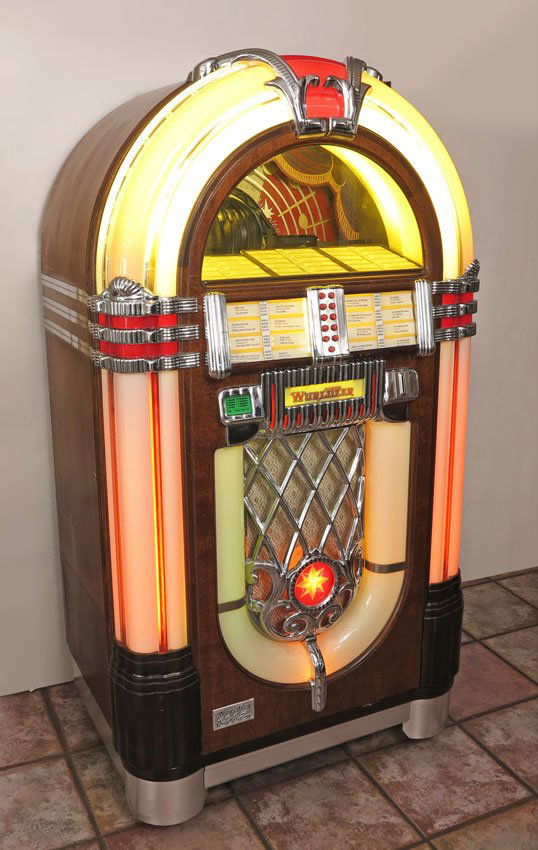 WURLITZER 1015 ONE MORE TIME JUKEBOX: WURLITZER 1015 ONE MORE TIME JUKEBOX: The iconic Wurlitzer 1015 model plays 45's records, this model produced in the 1980's. Loaded with 50 records from the 1950's, 60's, and 70's. Appears to be all o