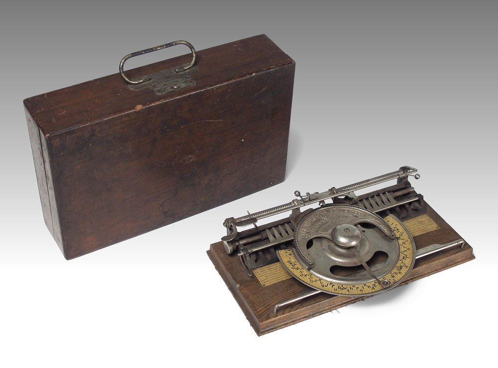 THE WORLD TYPE WRITER IN ORIGINAL CASE: THE WORLD TYPE WRITER IN ORIGINAL CASE: Manufactured by the Typewriter Improvement Company. Index wheel type typewriter, original instruction plaque inside. In the original case. Case measures 3 1/4''