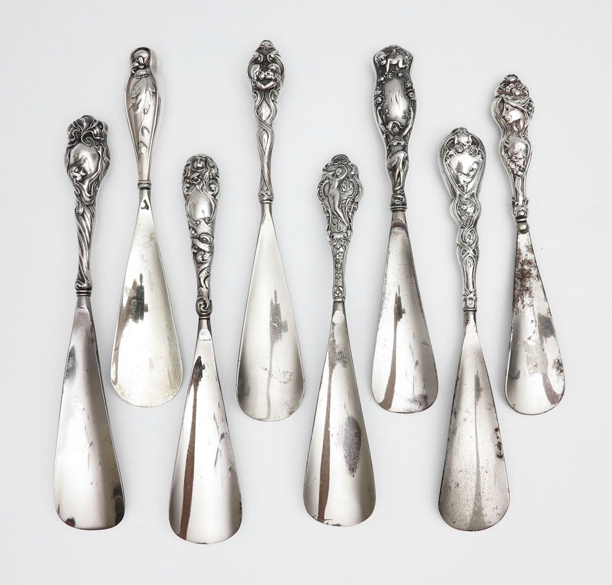 COLLECTION ART NOUVEAU STERLING SHOE HORNS: COLLECTION ART NOUVEAU STERLING SHOE HORNS: To include 1) Cupid atop pointing to woman below, marked Sterling. 2) Foster & Bailey, woman on hammock. 3) Full figure woman with arms above / atop her hea