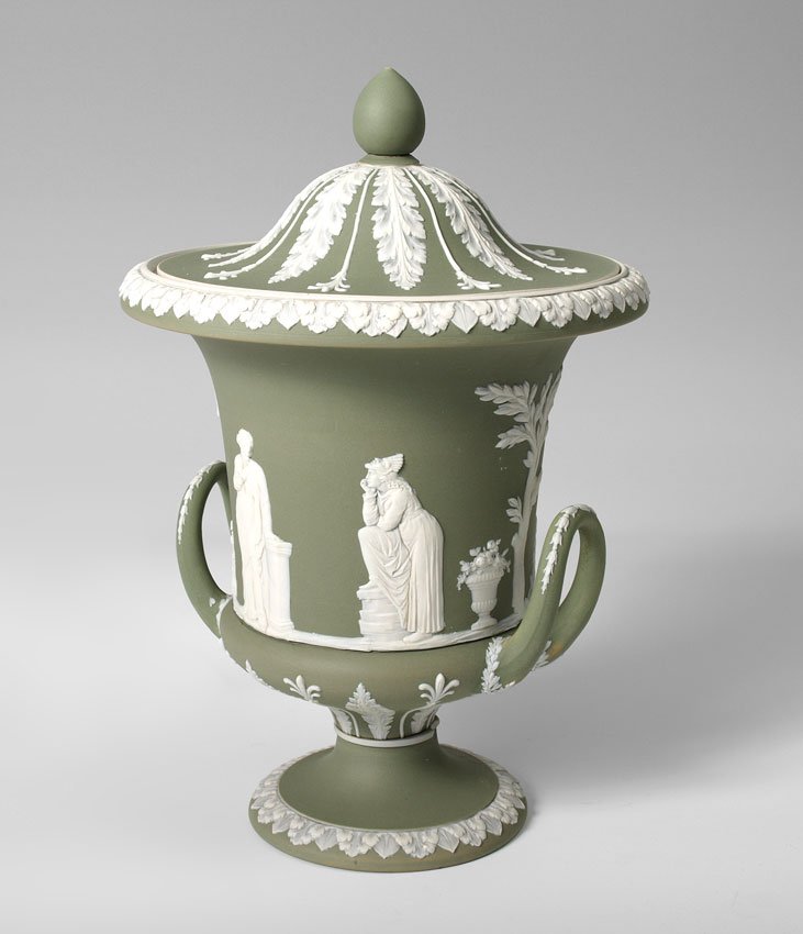 WEDGWOOD JASPERWARE COVERED URN: WEDGWOOD JASPERWARE COVERED URN: Ca. 1891-1921. Green with white classic figures, impressed ''Wedgwood'' and ''England''. 12 1/2'' tall x 8 1/2'' dia.