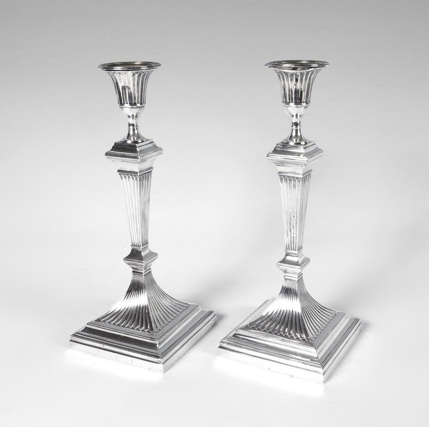 PAIR EDWARD HUTTON ENGLISH SILVER CANDLESTICKS: PAIR EDWARD HUTTON ENGLISH SILVER CANDLESTICKS: 1893 London hallmarks, by Edward Hutton of William Hutton & Sons. Single light, fluted architectural shaft with stepped weighted bases. Measures 12'' h.