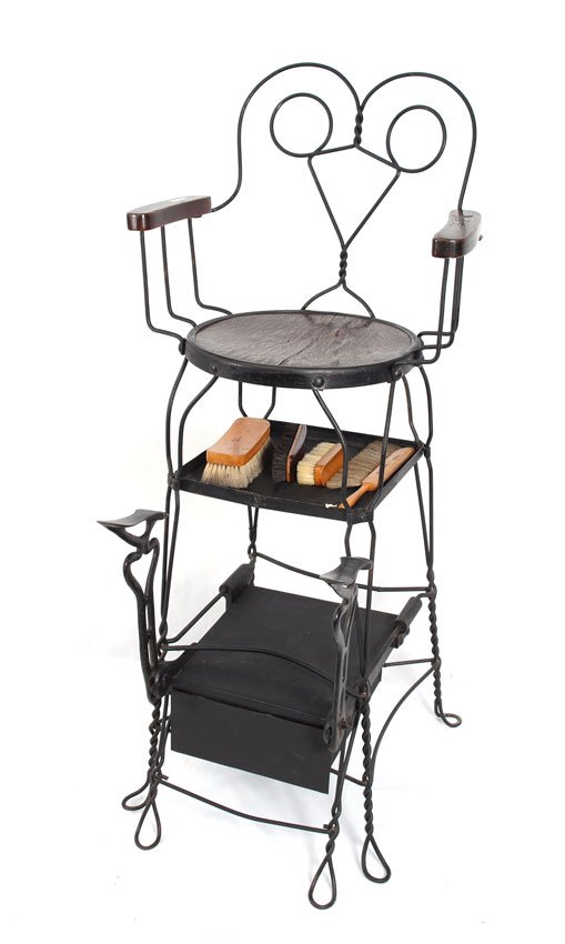 WROUGHT IRON SHOE SHINE STOOL/STAND: WROUGHT IRON SHOE SHINE STOOL/STAND: Twisted wrought iron frame with two foot stands, lower drawer for holding shoe shine equipment, wood seat and arms, measures, 53" h. x 16 3/4" x 30".
