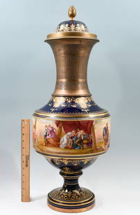 MID 19TH-CENTURY ORMOLU MOUNTED ROYAL VIENNA VASE: MID 19TH-CENTURY ORMOLU MOUNTED ROYAL VIENNA VASE: A large, mid-19th century ormolu mounted porcelain Royal Vienna vase with lid. Decorated in relief gilt foliate scroll upon a cobalt blue ground and