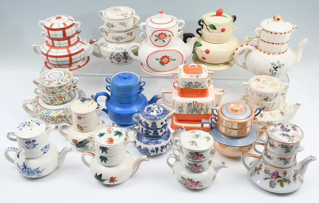 16 PC. STACKING TEAPOT COLLECTION: 16 PC. STACKING TEAPOT COLLECTION: Vintage stacking ceramic teapot collection. 16 stacked tea service sets, each composed of teapot, sugar, creamer, and at least a couple have plate bases. Many marked