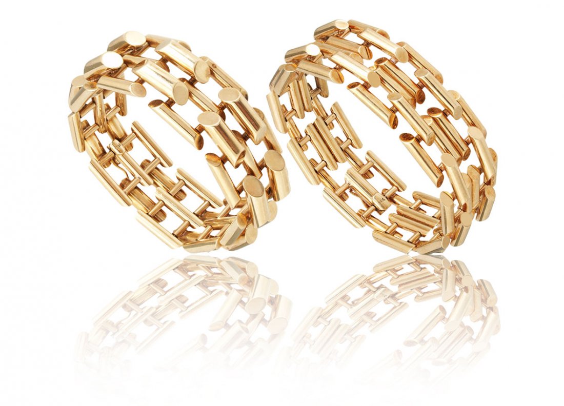 PAIR 14k GOLD ART DECO BRACELETS 124.3 GR.: PAIR 14K GOLD ART DECO SOFT CUFF BRACELETS: CA. 1935-1940. Each in a style slightly unique from the other with beveled baton links, locking closures and a figure eight clasp. Width: 1''. Lengths: 8 1/