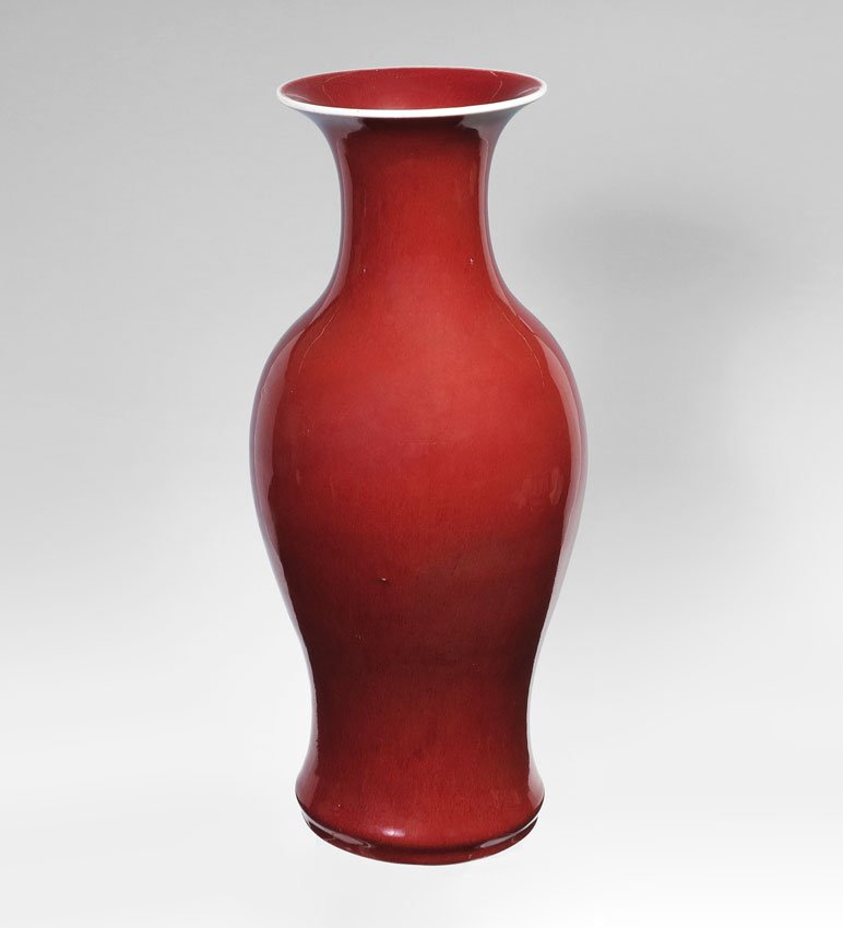 CHINESE SANG DE BOEUF PORCELAIN VASE 21.5'': CHINESE SANG DE BOEUF PORCELAIN VASE: In baluster form, on teak stand. Vase, circa 1850, 21 1/2'' high x 9 1/2'' diameter.