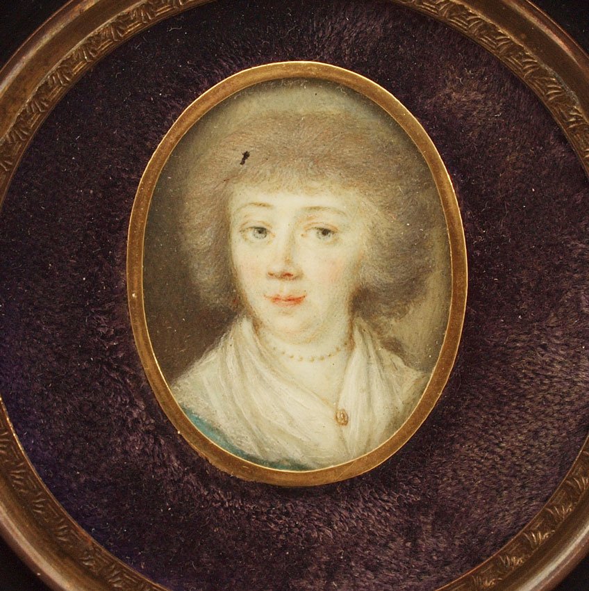 MINIATURE PORTRAIT PAINTING OF A MIDDLE AGED WOMAN: MINIATURE PORTRAIT PAINTING OF A MIDDLE AGED WOMAN: oval sight size 1 1/4'' x 1'', encased in ebonized carved wood frame with minor wear, 5'' x 5 1/8''.