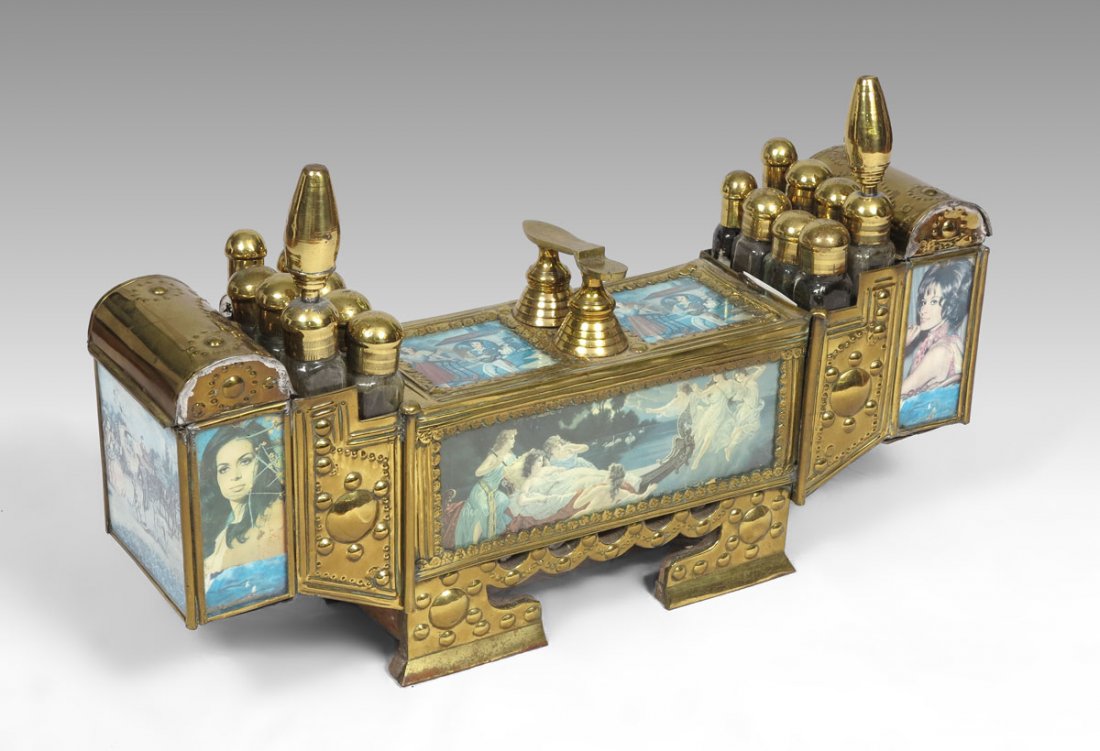 BRASS SHOESHINE OR VALET KIT: BRASS SHOESHINE OR VALET KIT: Hand crafted with a Middle Eastern flair, wood body with drawers, brass top with vignettes of man serenading a woman. Brass side compartments hold 16 brass top bottles an