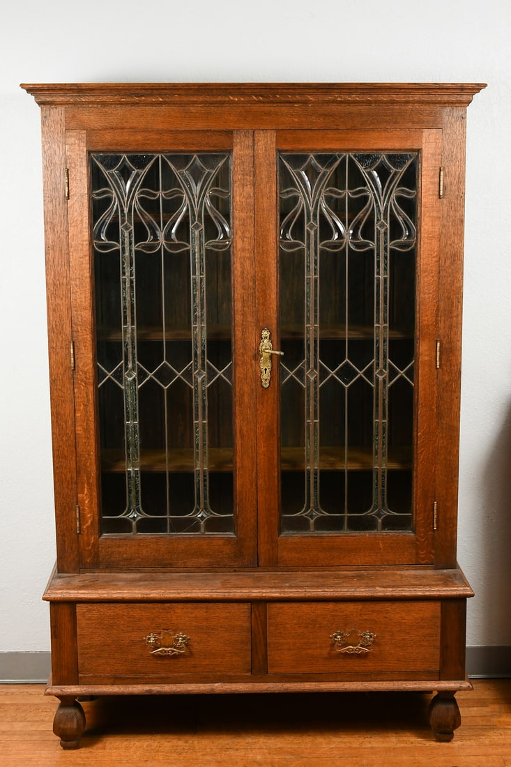 ART NOUVEAU 2-DOOR OVER 2-DRAWER LEADED BOOKCASE: ART NOUVEAU 2-DOOR OVER 2-DRAWER LEADED BOOKCASE: 2- Door Art Nouveau Stained Glass bookcase with 2- lower deep drawers with bail handles. Raised on carved paneled feet. Approx. 69.75" h x 45.5" w x 1