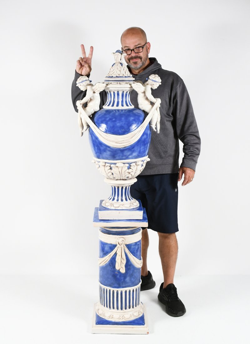 EZIO CECCARELLI PRIMAVERA ANGEL VASE & PEDESTAL: EZIO CECCARELLI PRIMAVERA TERRACOTTA ANGEL VASE W/ PEDESTAL: Large signed Ezio Ceccarelli Vase & pedestal, having two winged cherubs with draped cloth, resting upon the neck. Acanthus Leaves at the li