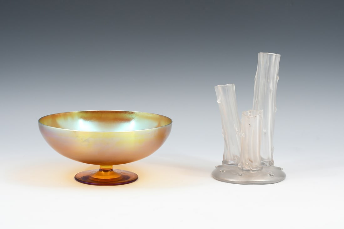 2 PC. STEUBEN ATTRIBUTED GLASS BUD VASE & COMPOTE: 2 PC. STEUBEN ATTRIBUTED GLASS BUD VASE & COMPOTE: Comprising; 1- Gold Aurene Compote, & 1- Clear Iridescent Tree trunk form bud vase. Tallest Approx. 6" h x 3.5" w x 3.625" d.