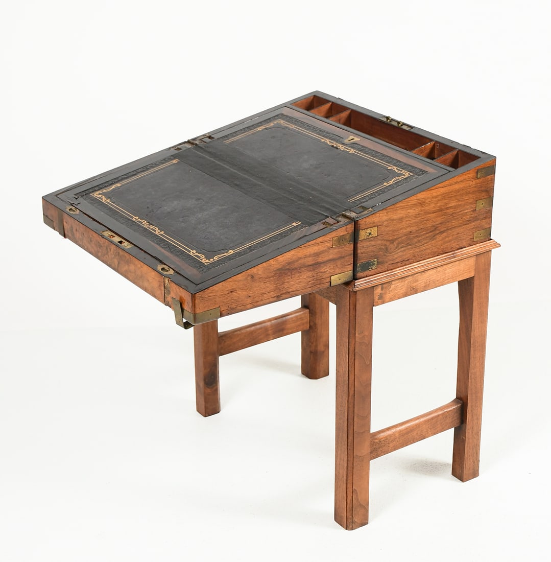 19TH-CENTURY ENGLISH LAP DESK ON STAND: 19TH-CENTURY ENGLISH LAP DESK ON STAND: Brass banded Walnut English Writing / Lap desk, early 18th-century resting upon a later stand. Desk Approx. 7.75" h x 17.75" w x 10.25" d. With stand Approx. 23