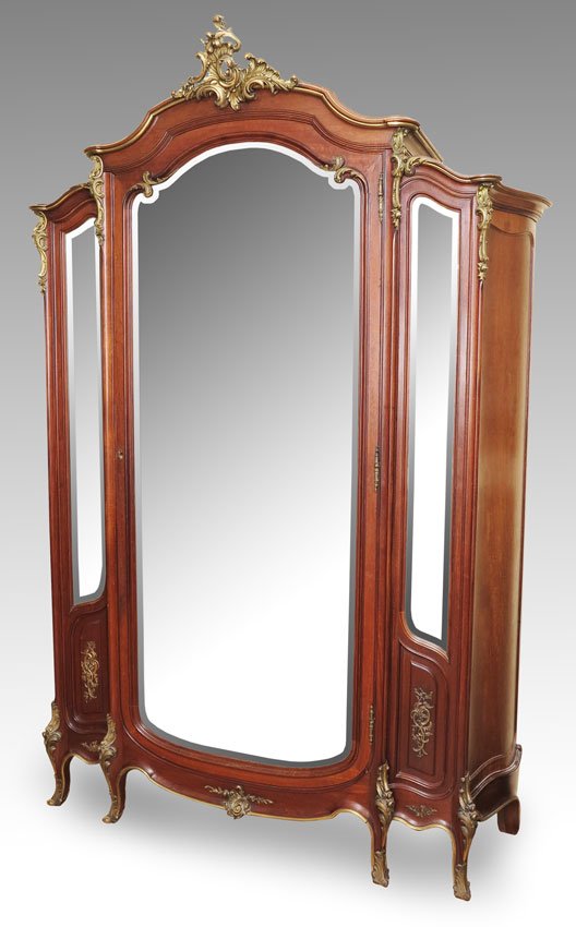 FRANCOIS LINKE QUALITY FRENCH ARMOIRE: FRANCOIS LINKE QUALITY FRENCH ARMOIRE: Foliate scroll ormolu crest, marked R on back, with shaped top. Central beveled glass mirror door surmounted by 2 beveled side mirrors. 3 shelves and 2 half draw