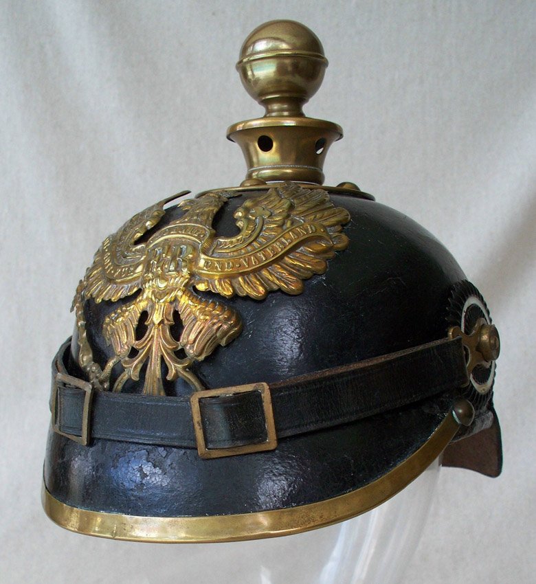 GERMAN WWI ARTILLERY PICKELHAUBE HELMET: GERMAN WWI ARTILLERY PICKELHAUBE HELMET: Crowned eagle with banner across wings and chest of eagle reads: Mit. Gott. Fur. Koenigh, Und. Vaterland. Cockades on both side present, as is chinstrap. 8'' h