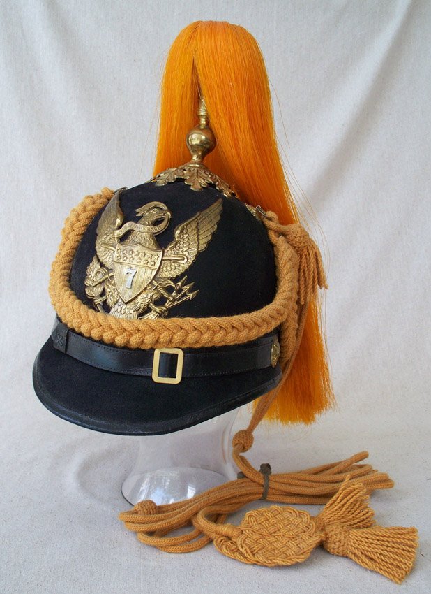 MODEL 1881 UNITED STATES 7TH CAVALRY HELMET: MODEL 1881 UNITED STATES 7TH CAVALRY HELMET: Indian Wars era, front badge with crossed swords behind shield on eagle's chest and 7th Cavalry designation. Marked Raymond & Whitlock, complete with cords