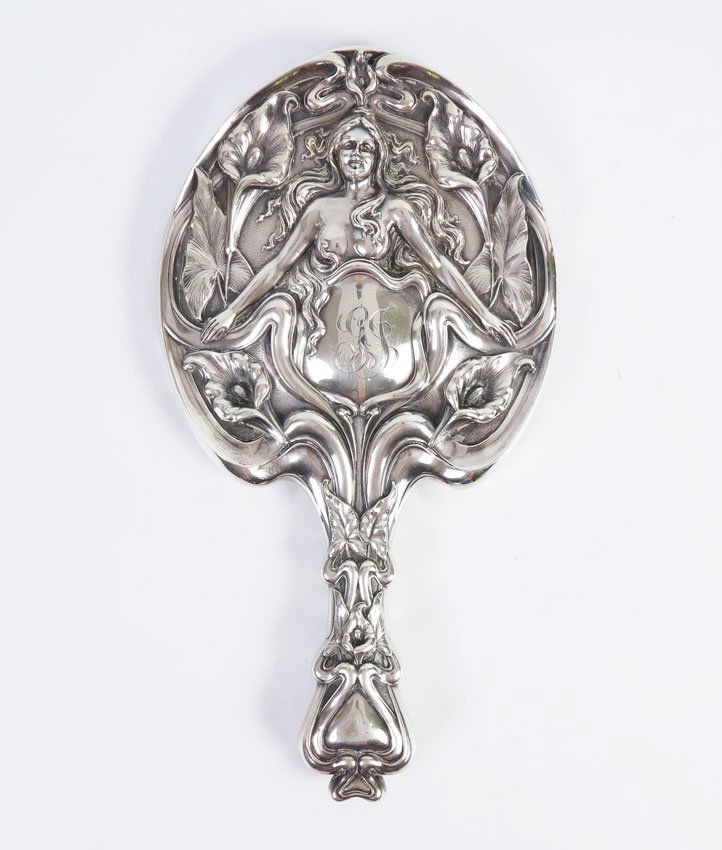 ART NOUVEAU STERLING SILVER MIRROR: ART NOUVEAU STERLING SILVER MIRROR: Woman, hair covering breasts, outstretched arms, Simon Bros., monogrammed, measures 10 3/8'' long.