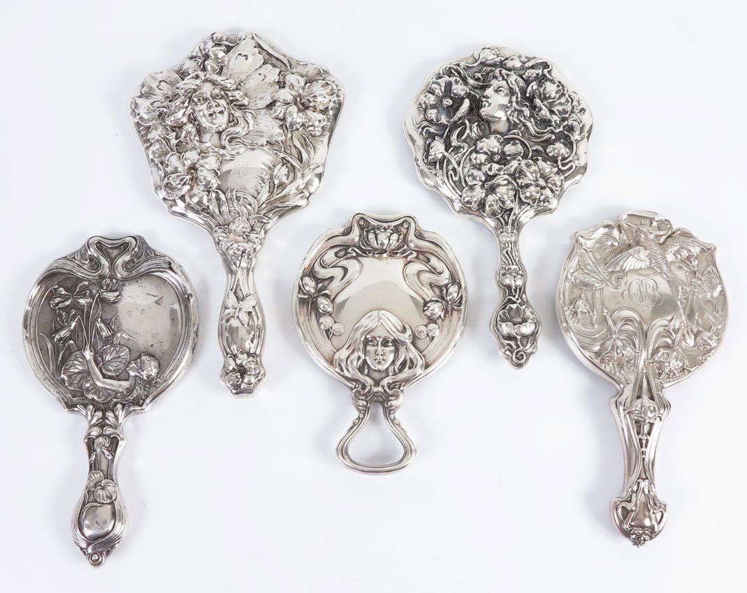 ART NOUVEAU SILVER MIRRORS: ART NOUVEAU SILVER MIRRORS: To include; 1) Girl's head at bottom, water lily, Simons Bros., rarer keyhole handle.; 2) Butterfly woman with smiling face, Woodside Sterling 11 1/2" l. 3) Woman below rig