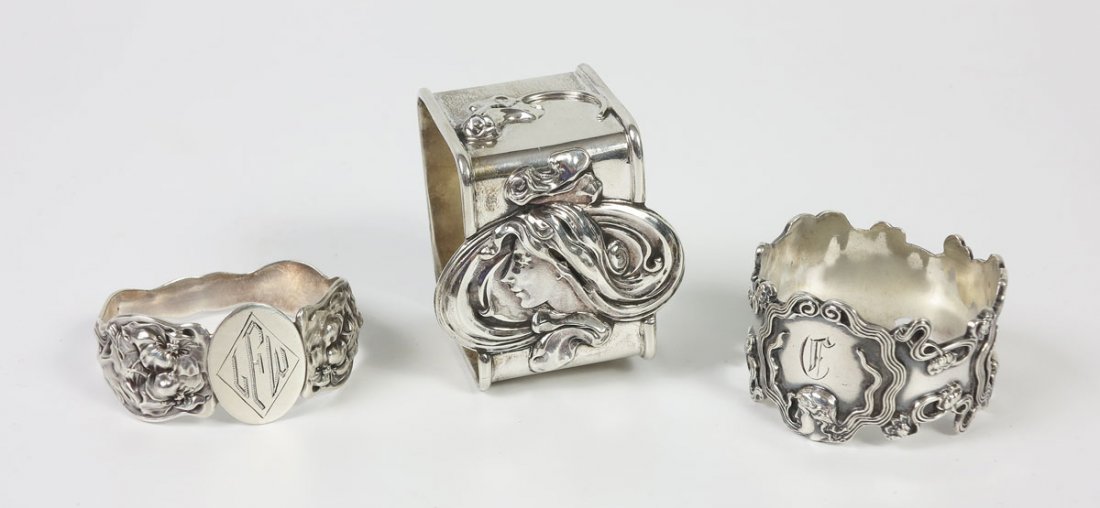 ART NOUVEAU STERLING FIGURAL NAPKIN RINGS: ART NOUVEAU STERLING FIGURAL NAPKIN RINGS: 3 to include 1) By LaPierre, square featuring woman with hair flowing beyond sides, monogramed Emma J Patton; 2) By Unger Bros, Evangeline pattern, monogramm