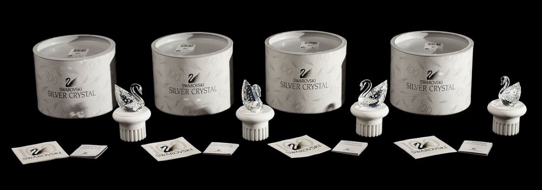 4 SWAROVSKI CRYSTAL THE CENTENARY SWAN FIGURINES: FOUR SWAROVSKI CRYSTAL FIGURINES, THE CENTENARY SWAN: 7633 100 000, Anton Hirzinger designer, issued 1995, each with stand, box and certificates.