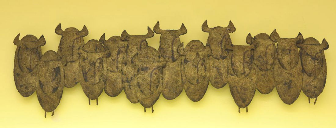 PETER PEPPER PRODUCTS BUFFALO SCULPTURE: PETER PEPPER PRODUCTS BUFFALO WALL SCULPTURE: In the style of Curtis Jere, bronzed metal 14 buffalo in a line. Peter Pepper Products label verso. 46" l. x 13 3/4".