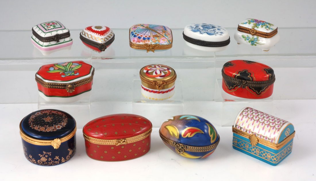 12 LIMOGES PEINT MEIN MINIATURE BOXES: A DOZEN FRENCH LIMOGES PEINT MEIN MINIATURE BOXES: Hinged top, hand painted porcelain boxes in the shape of an egg, sarcophagus, round, treasure chest, oval and a heart. The smallest being 1" x 1.2". 