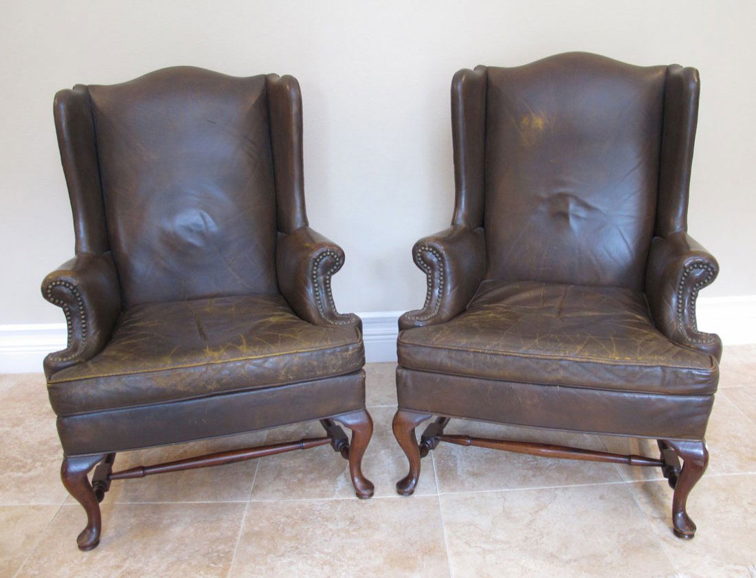 PAIR HICKORY CHAIR CO LEATHER WINGBACK CHAIRS: PAIR HICKORY CHAIR CO. LEATHER WING BACK CHAIRS: Decorative tacked leather in comfortable well worn condition. Measure approx. 42" tall x 26 1/4" x 31".