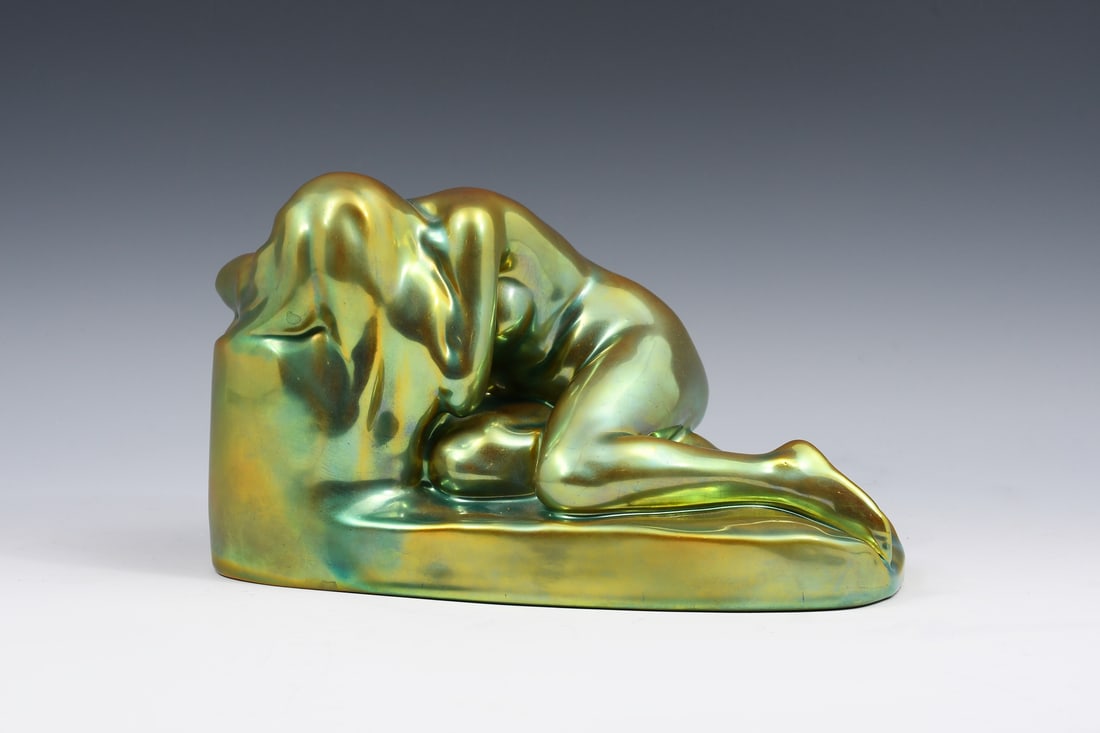 ZSOLNAY EOSIN "REPENTANCE" NUDE FIGURINE: ZSOLNAY EOSIN "REPENTANCE" NUDE FIGURINE: Yrjo Liipola for Zsolnay, "Repentance", a Bluish-Green Iridescent sculptural of a reclining nude woman. Circa 1900. Gold Zsolnay, Hungary stamp at the undersi