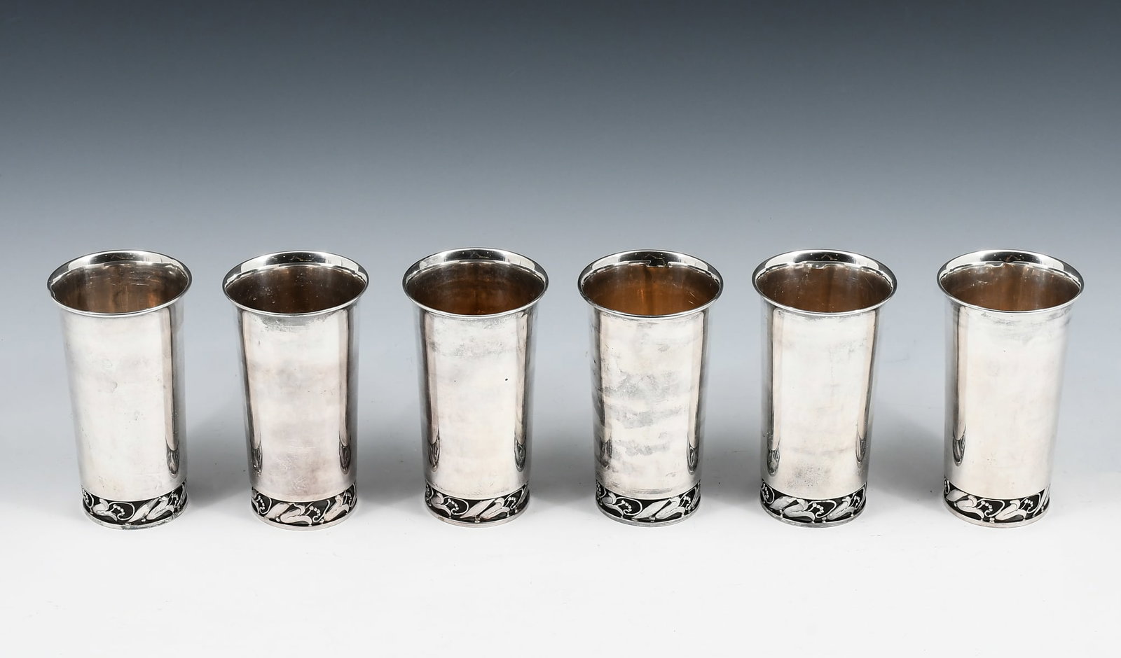 6 PC. GEORG JENSEN STYLE .950 STERLING JULEP CUPS: 6 PC. GEORG JENSEN STYLE .950 STERLING MINT JULEP CUPS: Approx. 24.10 Troy ounces. 6- .950 Sterling Silver Mint Julep cups, in the manner of Georg Jensen, having pierced stylized floral feet. Impresse
