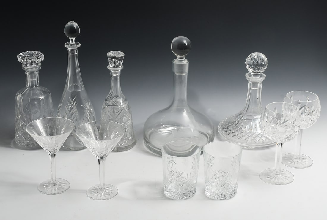 11 PC. CRYSTAL BARWARE INCLUDING WATERFORD & BACCARAT: 11 PC. CRYSTAL BARWARE INCLUDING WATERFORD & BACCARAT: To Include: 5- Decanters with stoppers of varying shapes and sizes; 2- Champagne Glasses; 2- Wine Glasses; 2- Highball Glasses.