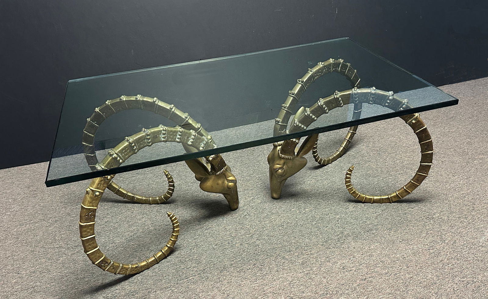 VINTAGE BRASS IBEX AND GLASS COFFEE TABLE MANNER OF ALAIN CHERVET: VINTAGE BRASS IBEX AND GLASS COFFEE TABLE MANNER OF ALAIN CHERVET: Approximately 19.5" x 49.75 x 26". Beveled glass is 3/4" thick.