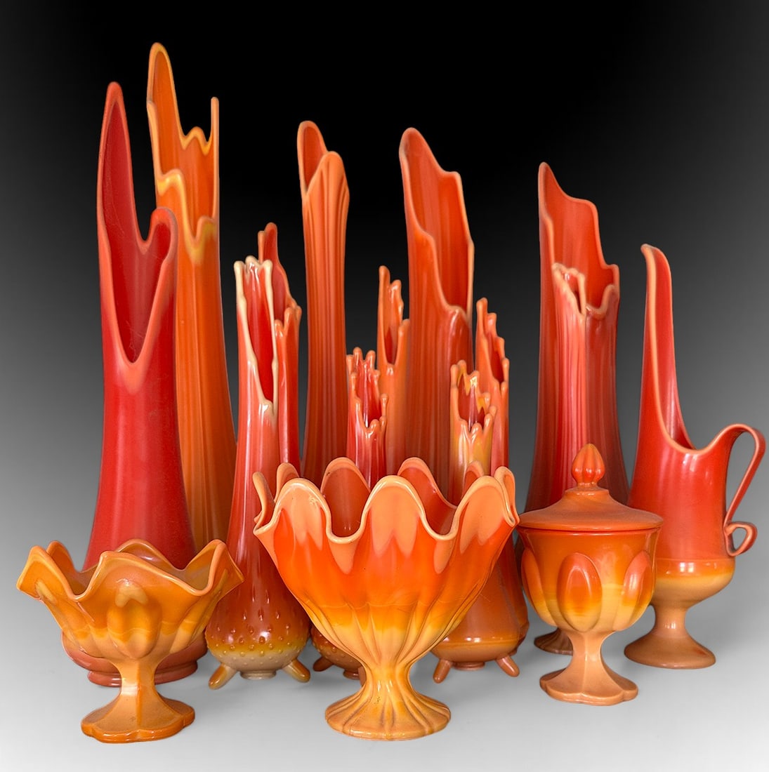 15 L.E. SMITH & VIKING BITTERSWEET SELENIUM GLASS: 15 PC. L.E. SMITH & VIKING BITTERSWEET ORANGE SELENIUM GLASS: A collection of 15 pc. Mid-Century Modern swung glass vases, Lidded Compote, & Open Compotes. Largest Approx. 25.75" h x 6" Dia. Shortest 