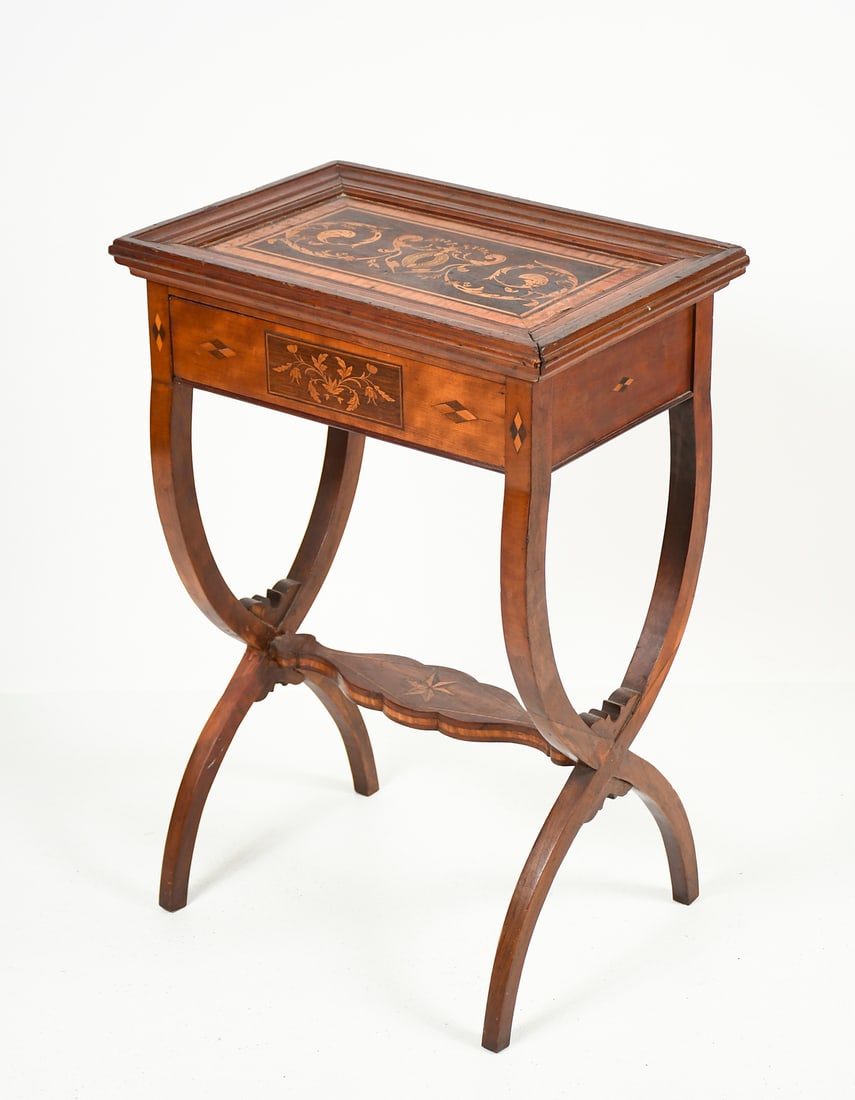 19TH-CENTURY MARQUETRY INLAID SPIDER LEG TABLE: 19TH-CENTURY MARQUETRY INLAID SPIDER LEG TABLE: A compact marquetry side table with an inlaid plant and vine design on the surface. Curving crossed spider legs. 28.25" (h) x 19.25" (w) x 13" (d).