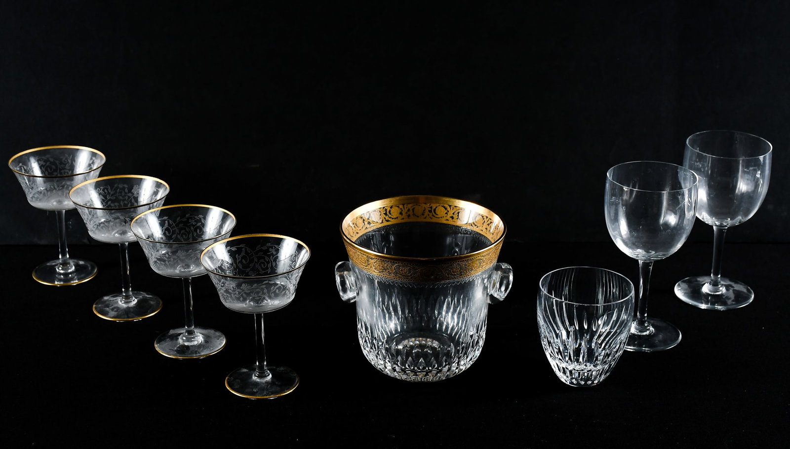 8 PC. BACCARAT & ST. LOUIS GLASS: 8 PC. BACCARAT & ST. LOUIS GLASS: Comprising: 4- Gold-Rimmed Foliate-Motif etched Champagne Glasses; 1- Gold-Rimmed Ice Bucket; 1- Tumbler Glass; 2- Wine Glasses. Largest Approx. 7" h x 3.97" Dia.